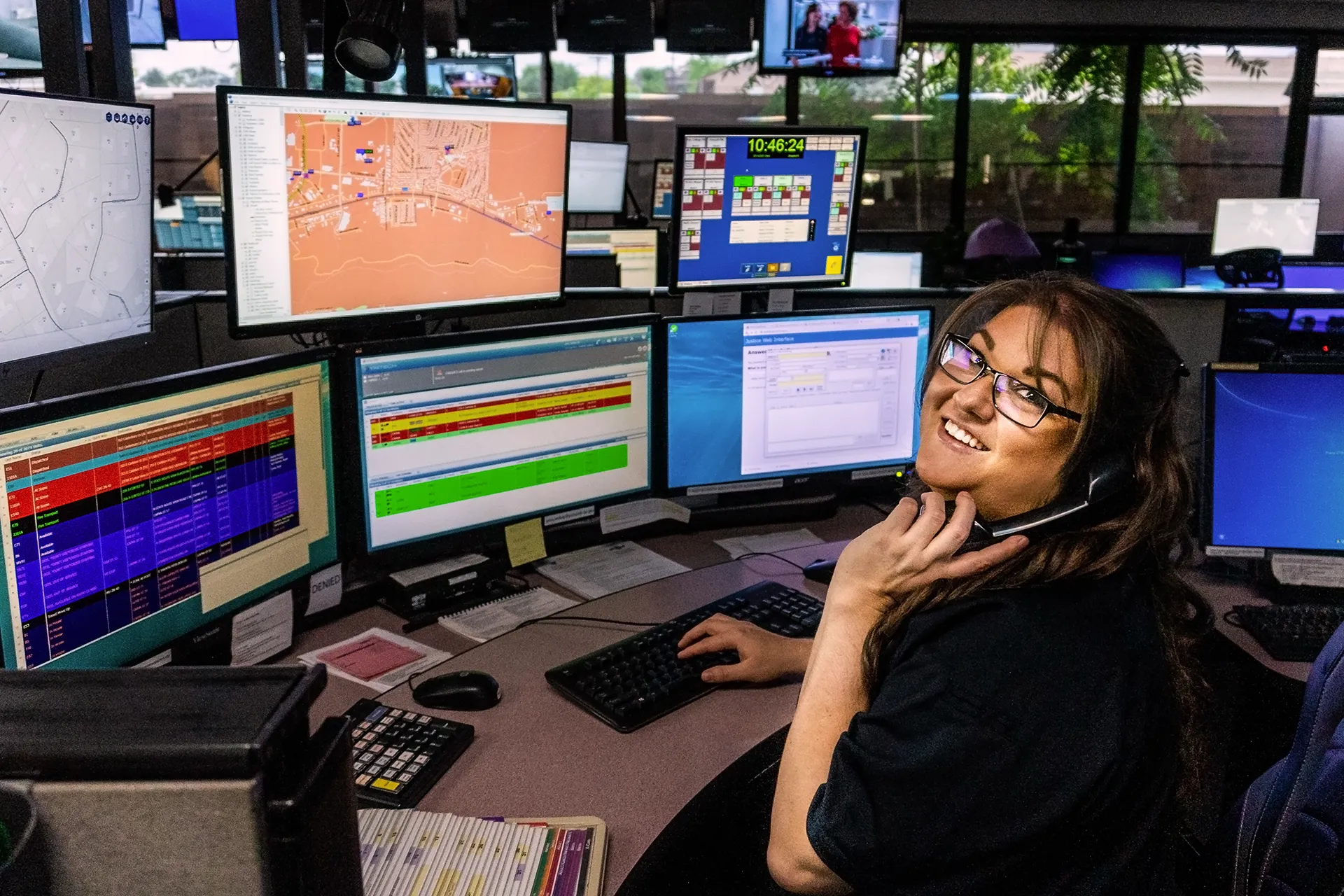 Prescott Regional Communications Center PRCC dispatcher smiling at camera.